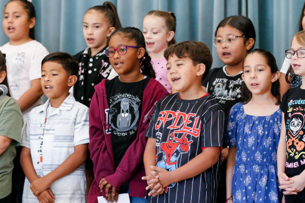 Second grade students sing on stage