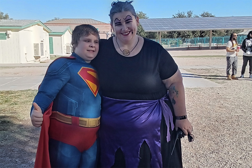 A boy dressed as Superman and a woman dressed as a witch