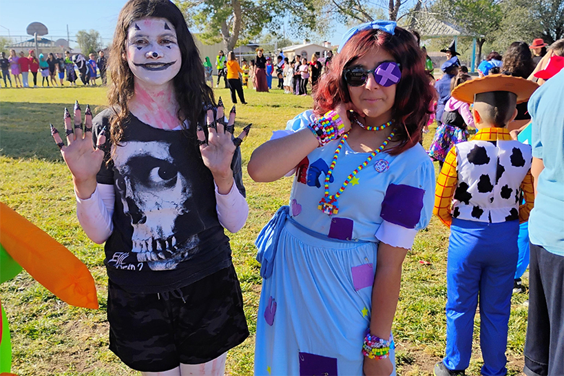 Two girls show off their costumes