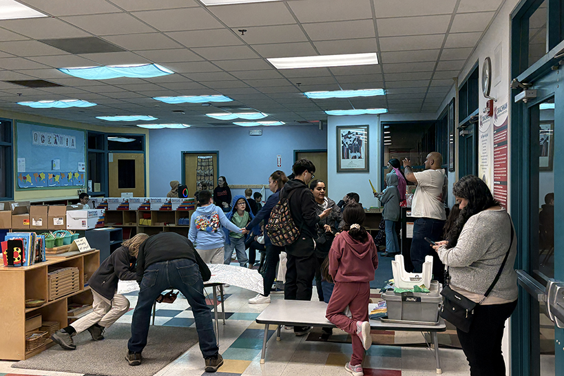 Families explore the school library