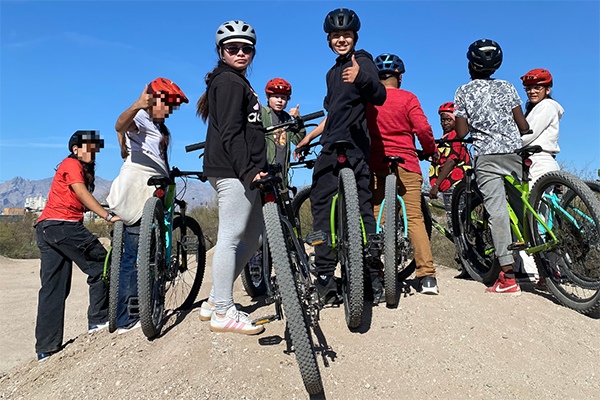 Students and staff pose for a photo on their bike ride