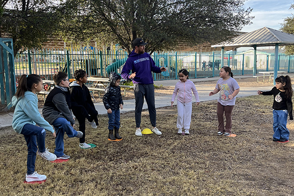 Students play games outside in a circle