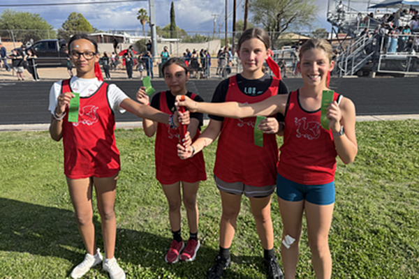 The four members of the girl's relay team pose with their award ribbons